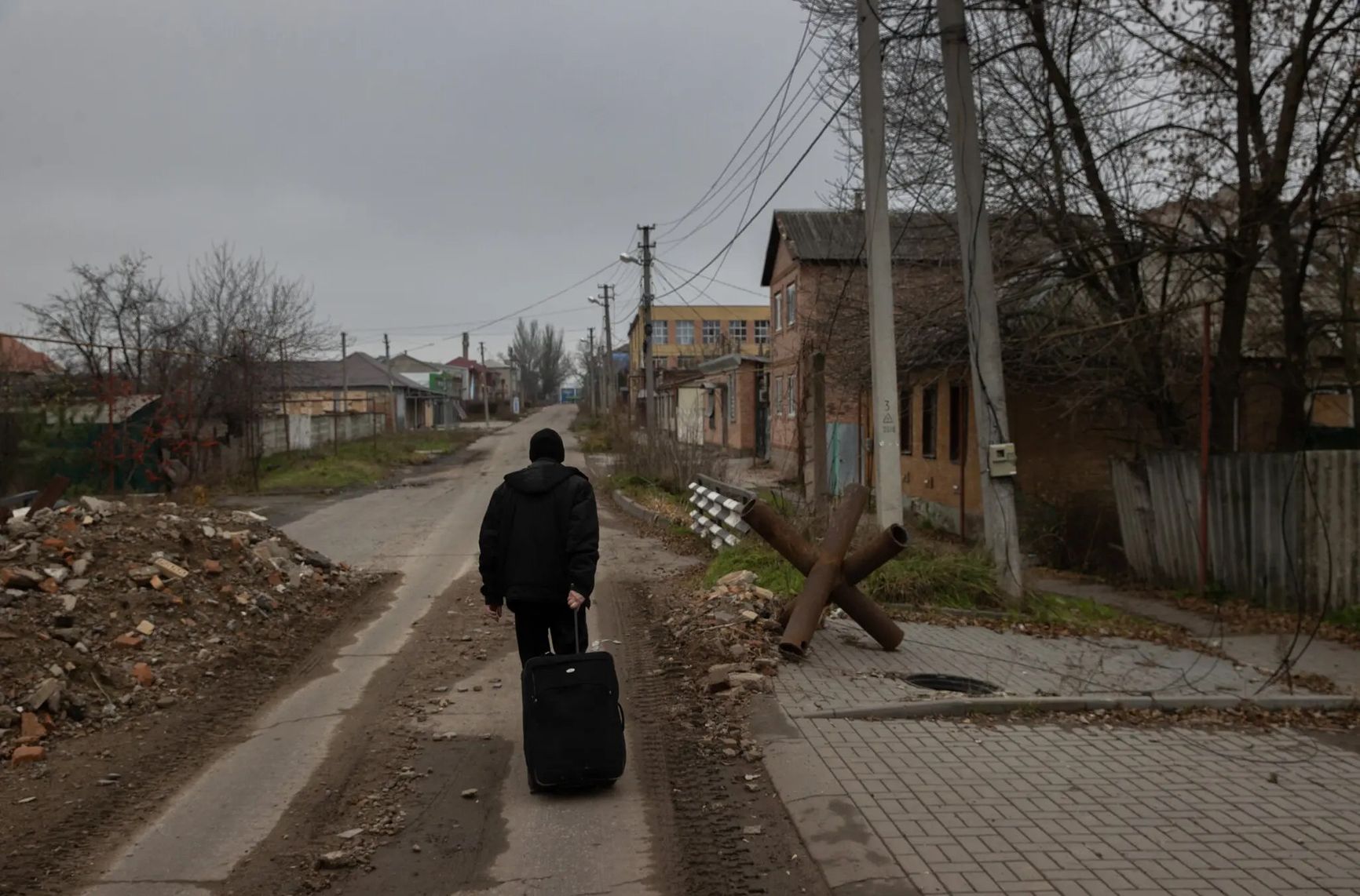 A Bakhmut resident walks down one of the town's deserted streets.