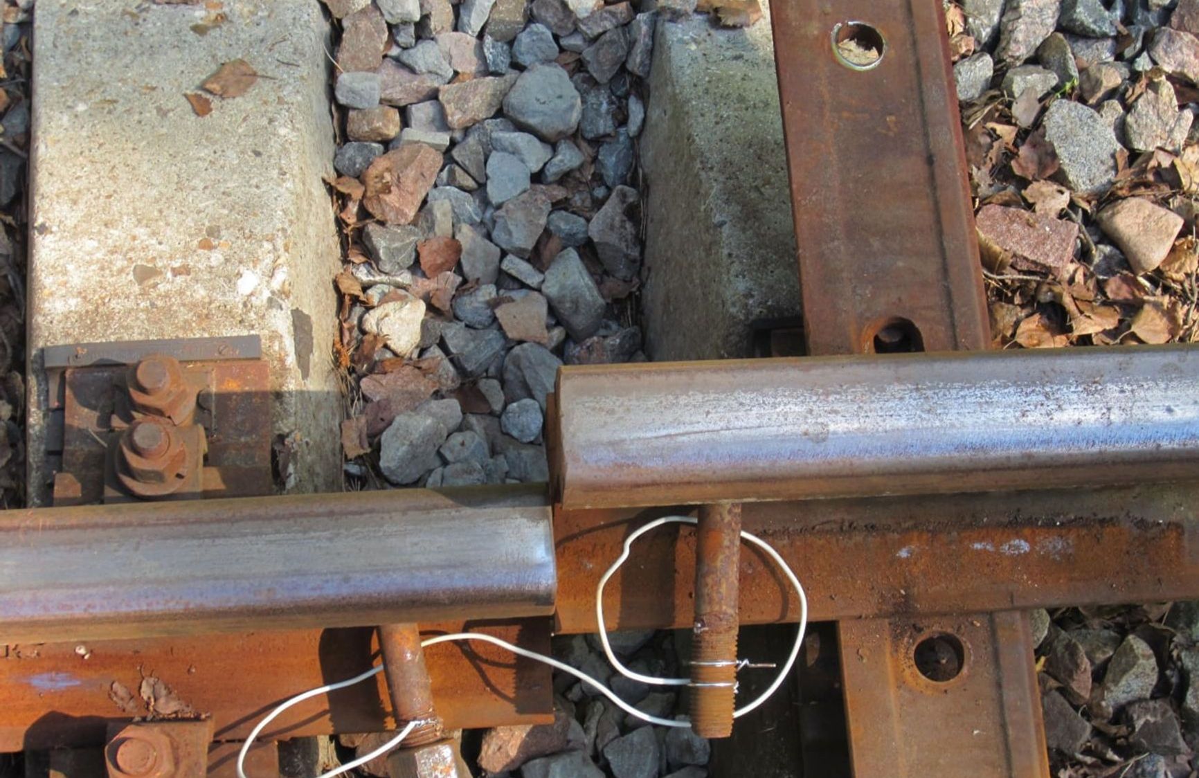 Sabotaged railroad siding leading to a military unit. The rails are shorted with a wire to prevent signaling current from detecting a gap